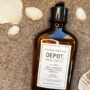 Depot No. 102 Anti-Dandruff & Sebum Control Shampoo 250 ml i brun glassflaske på sand med skjell – Nalu Nalu Frisør